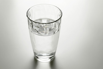 Glass of fresh water on grey table
