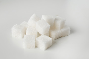 Cubes of sugar on light background
