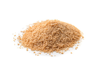 Heap of granulated brown sugar on white background