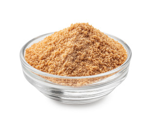 Granulated brown sugar in bowl on white background