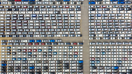 Cars export terminal in export and import business and logistics. Shipping cargo to harbor. Water transport International. Aerial view and top view.
