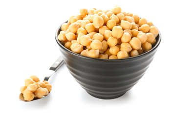 Bowl and spoon with chickpeas on white background