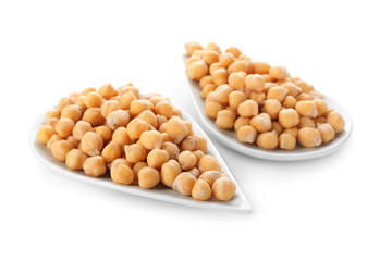 Plates with chickpeas on white background