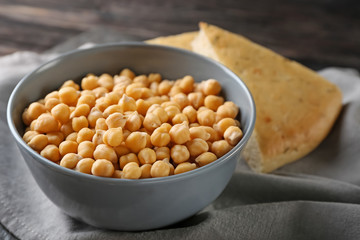 Bowl with chickpeas on table
