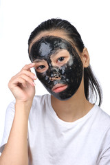 Asian woman with black spa mask