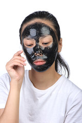 Asian woman with black spa mask