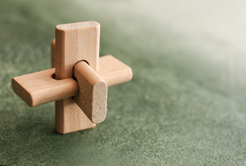 Wooden puzzle on color background