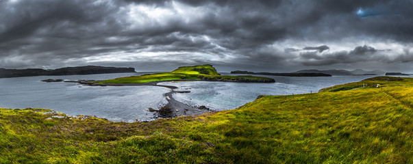 Stony Sandbank To Sunlit Green Island At Low Tide On The Isle Of Skye In Scotland