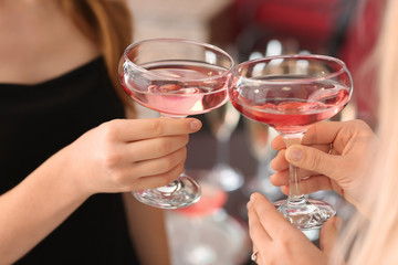 Young women drinking champagne at party