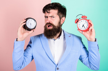 Guy unshaven puzzled face having problems with changing time. Time zone. Does changing clock mess...