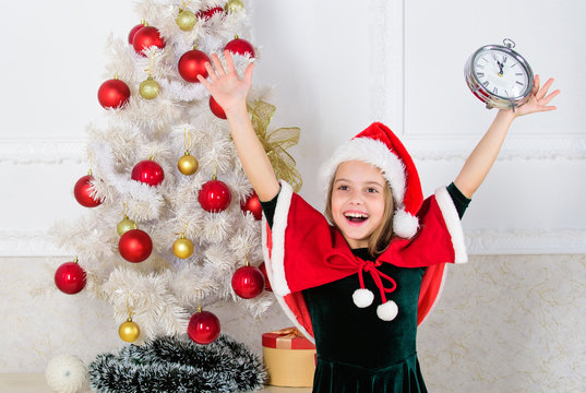 Girl kid santa hat costume with clock excited happy face counting time to new year. Last minute new years eve plans that are actually lot of fun. Last minute till midnight. New year countdown