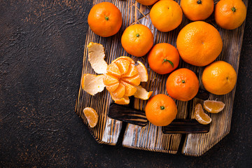 Fresh ripe tangerines on wooden board