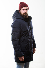 Hipster modern fashion. Guy wear hat and black winter jacket. Hipster style menswear. Hipster outfit. Man bearded hipster posing confidently in warm black jacket or parka. Stylish and comfortable