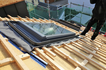 Roofer installing a skylight