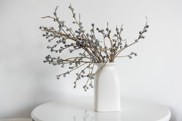 Minimal elegant composition with dried flowers on table. Vase of dried flowers with white wall...