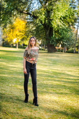 Photographing a girl during autumn with a blurred background