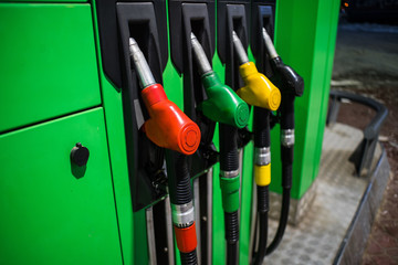 Fueling nozzles in different colors on green bright station