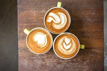 Top view Three Latte art on wooden table