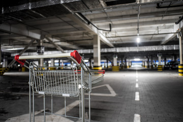 Chrome store trolley at underground parking with illuminated background