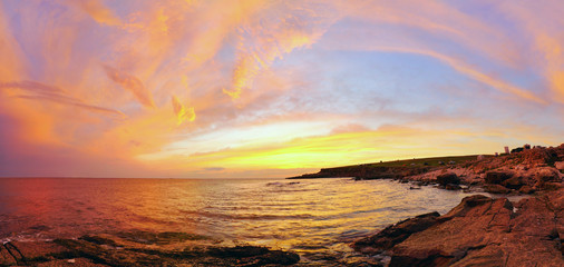 Fototapeta na wymiar Golden clouds at sunset over the black sea . Panorama.