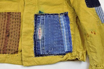 Khaki vintage jacket with patchwork decor sashiko detail, on a white background