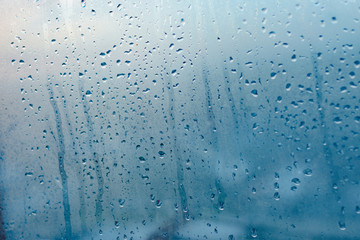 Strong humidity in wintertime. Water drops from home condensation on a window. Misted glass...