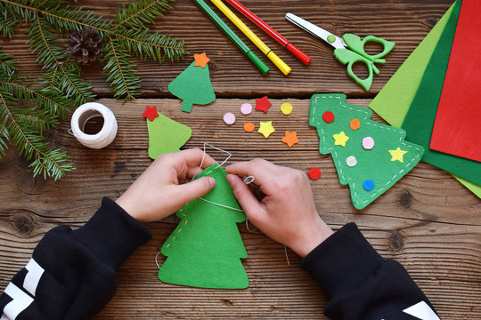 Making of handmade christmas tree from felt with your own hands. Children's DIY concept. Making xmas toys decoration or greeting card.