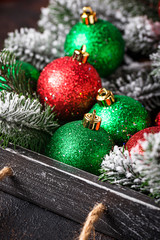 Red and green Christmas tree balls in wooden box
