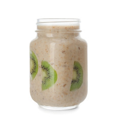 Mason jar with tasty oatmeal and kiwi slices on white background