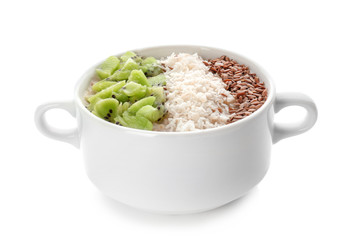 Casserole with tasty oatmeal, sesame seeds and kiwi on white background