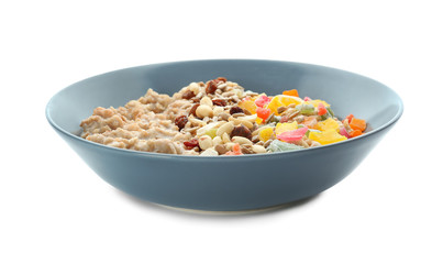 Plate with tasty oatmeal, nuts and succades on white background
