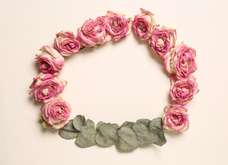 Frame made of beautiful dry roses on white background