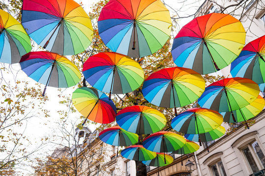 Colourful umbrellas decoration in the city street of Paris, joyful mood of multi coloured umbrellas.The roof top hanging on colorful umbrellas.