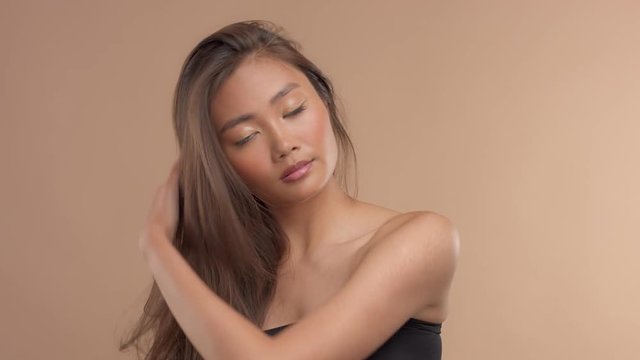 thai asian model with natural makeup on beige background