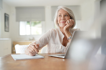  Elderly woman working on computer at home