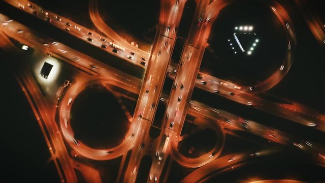Highway cloverleaf interchange junction with ramps, heavy traffic, aerial hyperlapse