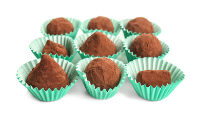 Tasty chocolate truffles on white background