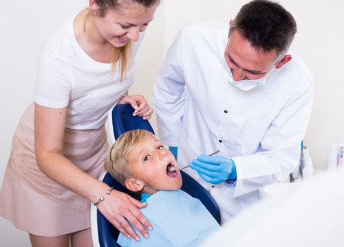 Woman with son are visiting dentist