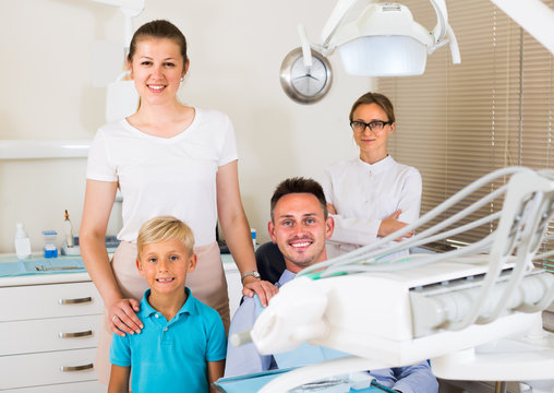 Father of the family is sitting in dental chair
