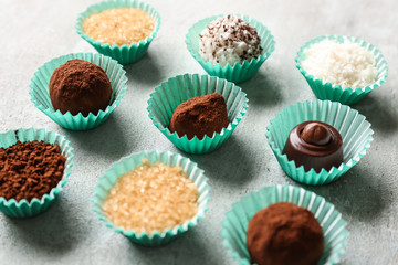 Different tasty chocolate truffles on light table