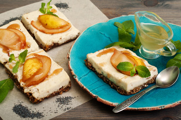 Raw food dessert. Paste from coconut milk, cashew nuts and sugar-free syrup on a cushion of seeds,...
