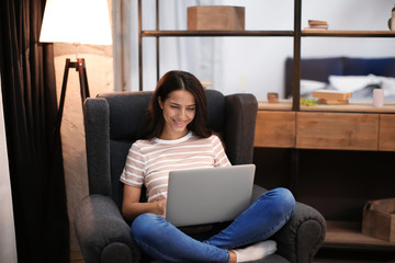 Young woman working with laptop at home