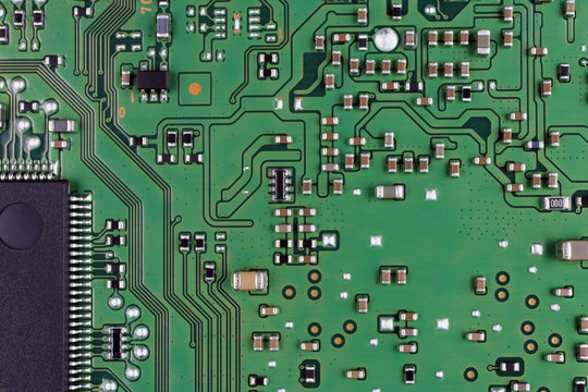 Microchips and microcircuits are installed on a modern electronic circuit board.