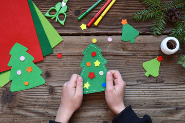 Making of handmade christmas tree from felt with your own hands. Children's DIY concept. Making...