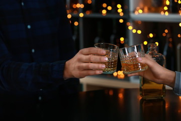 Couple drinking whiskey in bar