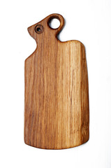 Oak cutting board on a white background. The handle of the board is stylized under the head of a ram or mouse.