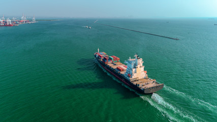 Aerial view container ship going to sea port for unload container for import export, shipping or...
