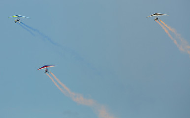 Flex-wing trikes flying in sky on air show