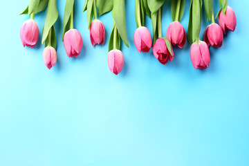 Beautiful tulips for Mother's Day on color background