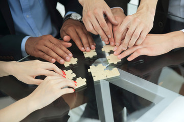close up .multinational business team assembling puzzle.
